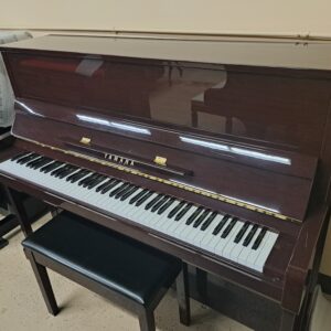 This is a picture of a used Yamaha B3 upright piano. It has a polished mahogany finish.