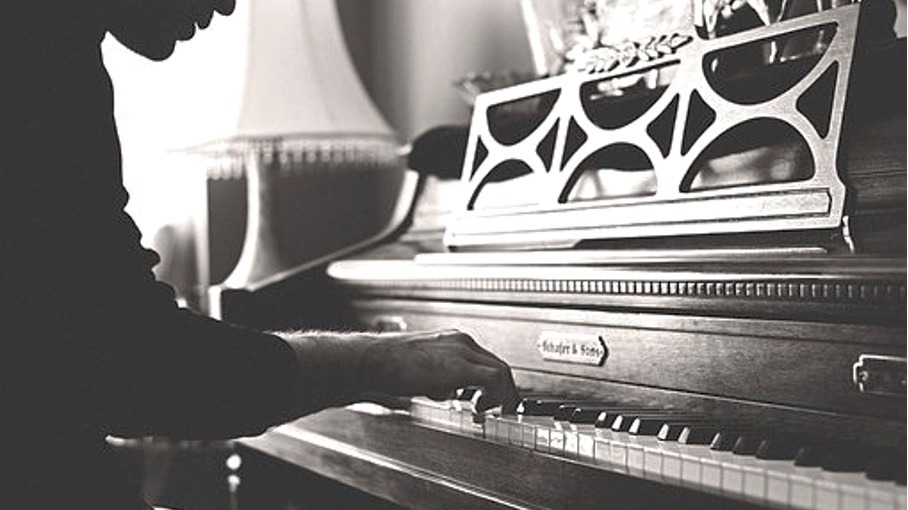 a man playing an old piano